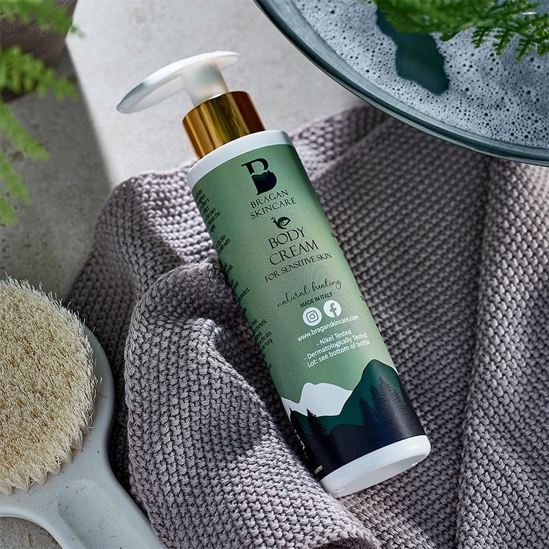 Bragan Skincare's body cream sitting on a grey towel