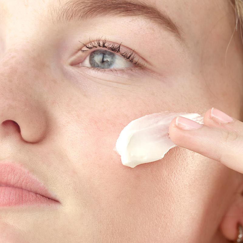 unscented moisturiser, fragrance-free moisturiser, snail mucin cream, Lady applying Face Cream