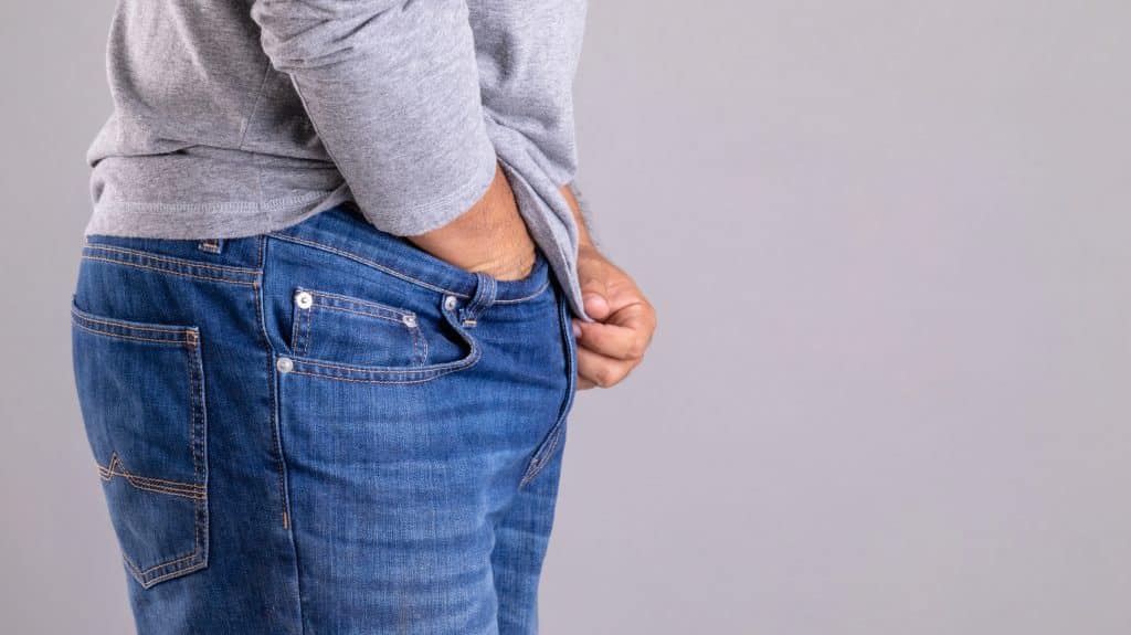 Man experiencing irritation in the genital area