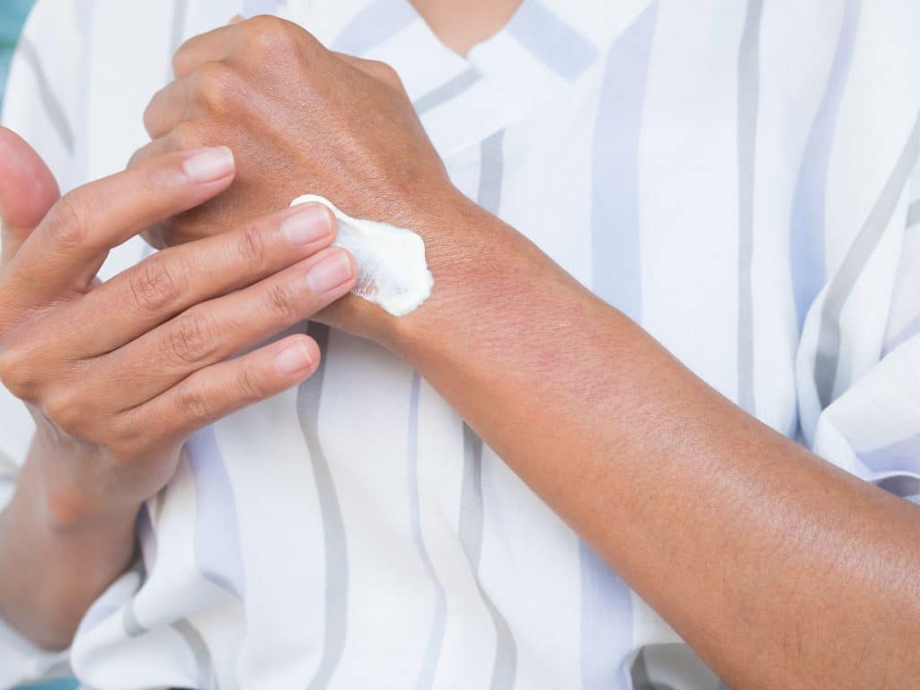 Person applying moisturiser to hands