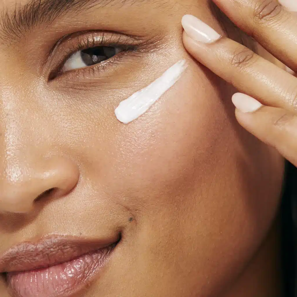 woman applying snail mucin cream for sensitive skin